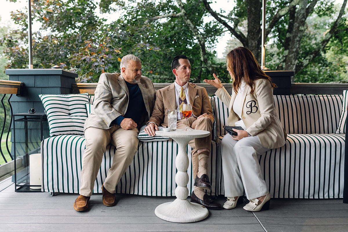 Wedding guests and groom at cocktail reception