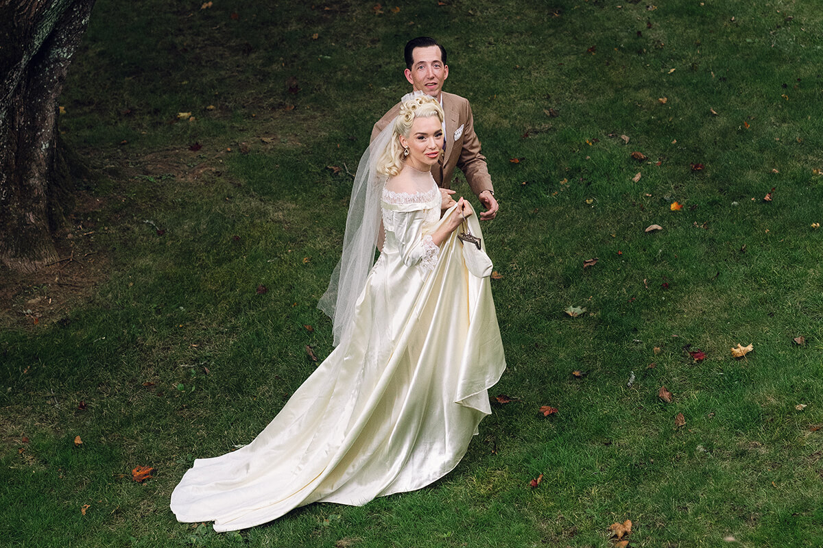 Newly married couple walking on lawn